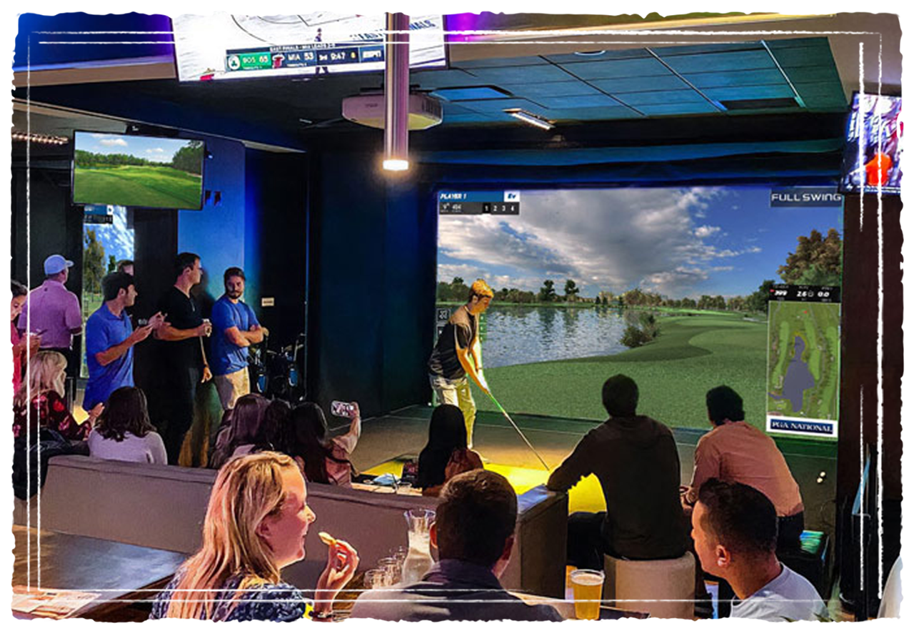 Large group of guests enjoying indoor golf simulators over shareable food and drinks
