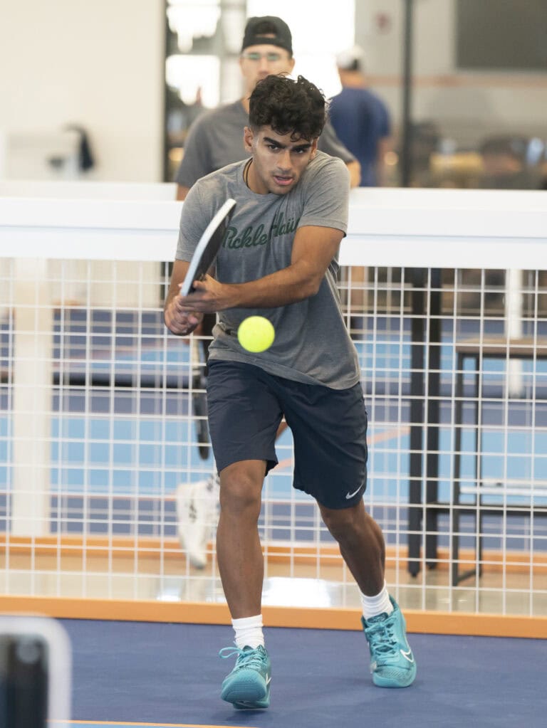 Man playing pickleball indoors