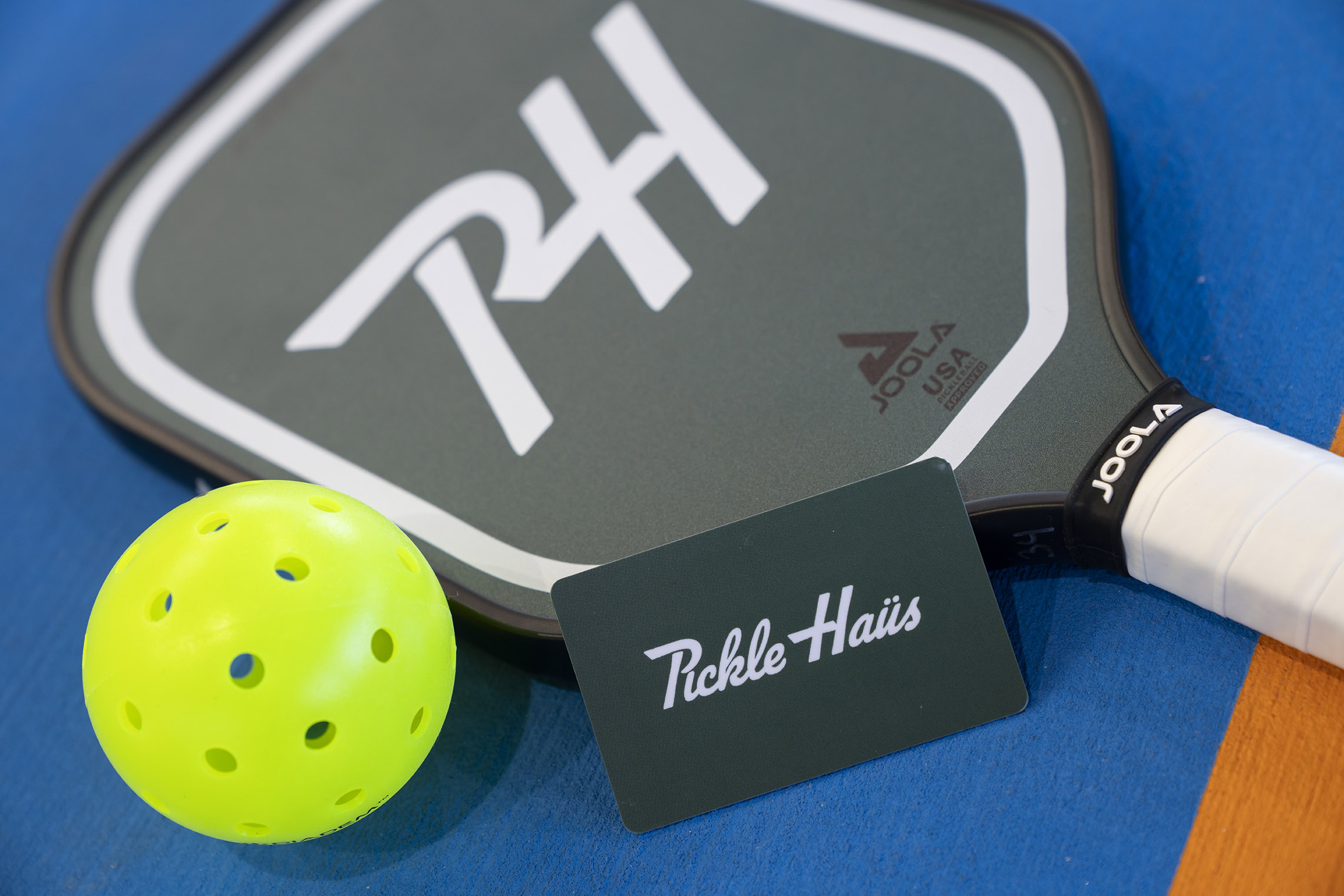 pickleball racquet, ball and gift card for pickle haus